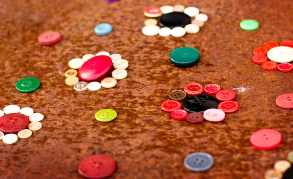 Spools of threads and buttons on old wooden table — Stock Photo, Image