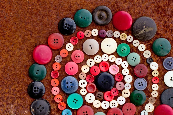 Spools of threads and buttons on old wooden table — Stock Photo, Image