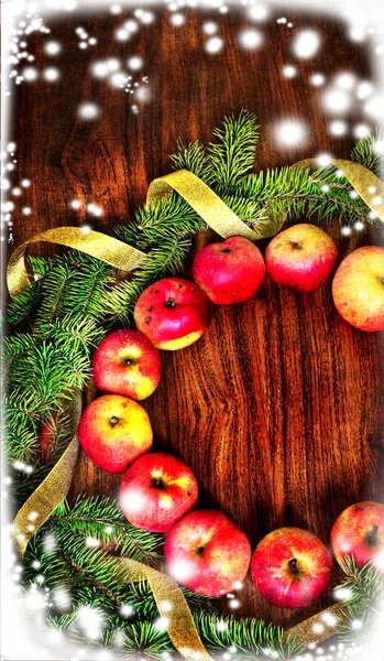 Christmas tree with apples and decorations on a wooden board — Stock Photo, Image