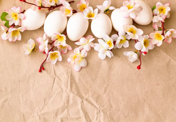 Huevos de Pascua y rama con flores sobre papel, fondo de Pascua, tarjeta de primavera —  Fotos de Stock