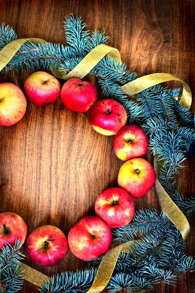 Christmas tree with apples and decorations on a wooden board — Stock Photo, Image