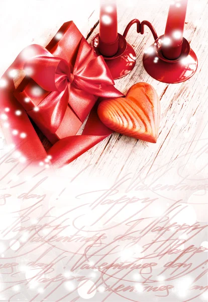 Valentines Day background with heart and holidays gift on old wooden background with two candle — Stock Photo, Image