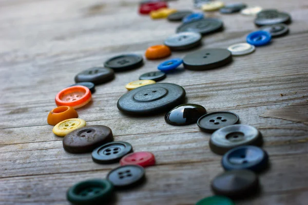 Spools of threads and buttons on old wood table — Stok Foto