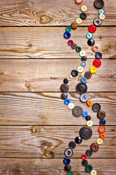 Set of vintage buttons on old wooden table — Stock Photo, Image