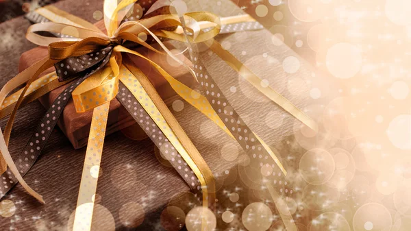 Two foil gifts with yellow,gold,brown bows — Stock Photo, Image