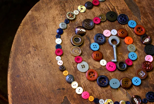 Set of vintage buttons on old wooden table — Stock Photo, Image