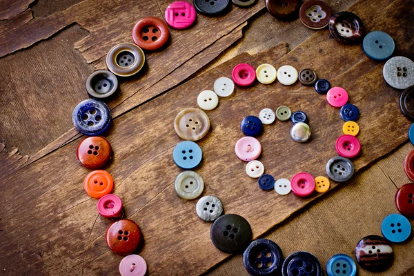 Set of vintage buttons on old wooden table — Stock Photo, Image