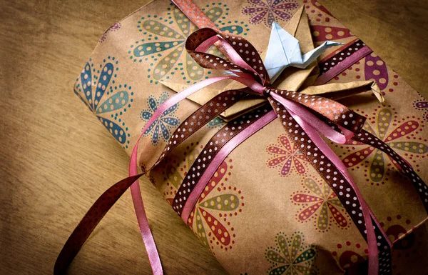 Gifts with packaging paper and atlas bows — Stock Photo, Image