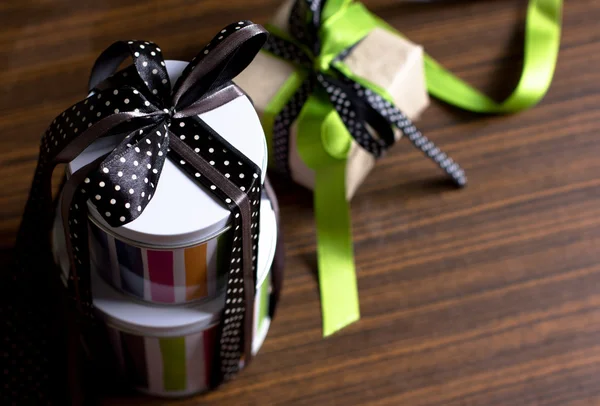 Gifts with packaging paper and atlas bows — Stock Photo, Image