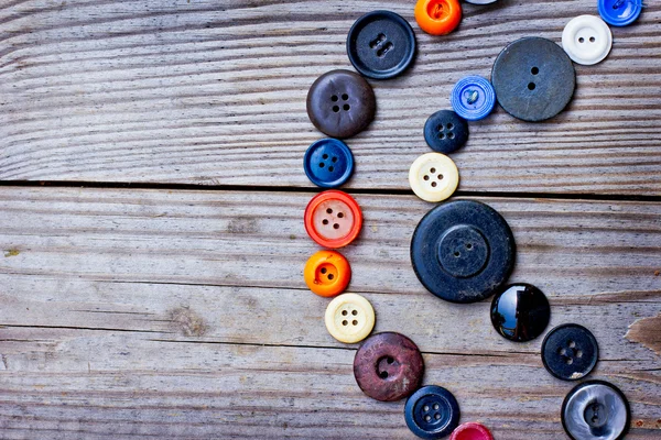 Set of vintage buttons on old wooden table with grunge texture — Stock Photo, Image