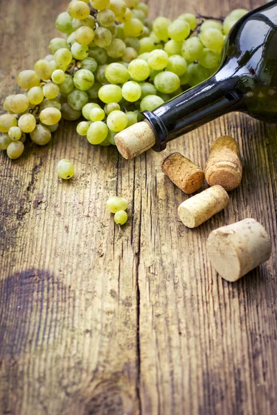 Bottle of white wine, grape and corks — Stock Photo, Image