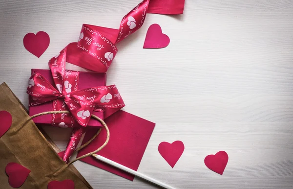 Ribbon, gift, hearts, pencil and paper — Stock Photo, Image