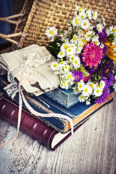 Background with flowers, post cards and books — Stock Photo, Image