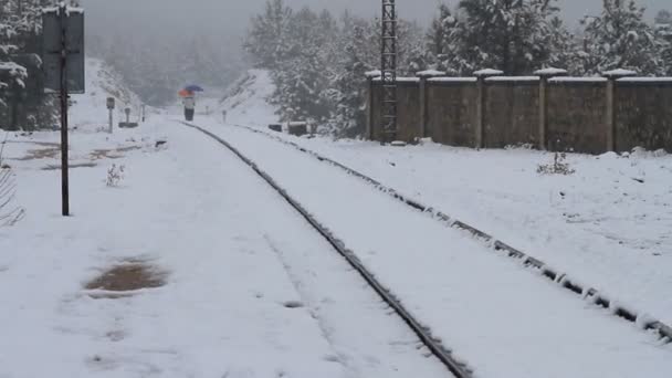 Walking over railways while snowing — Stock Video