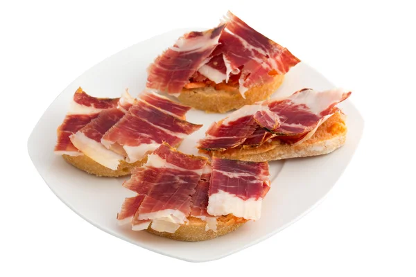 Spanish tapas, ham and tomato — Stock Photo, Image