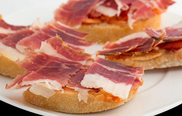 Spanish tapas, ham and tomato — Stock Photo, Image