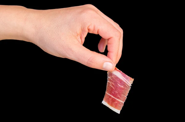 Picking serrano ham on black — Stock Photo, Image