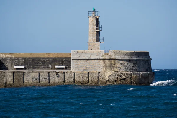 Stein-Leuchtturm über Meer und blauem Himmel — Stockfoto