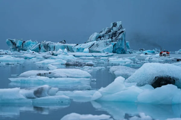 Icebergs em Jokulsarlon e grupo de turistas sobre barco — Fotografia de Stock