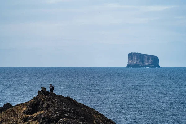 游客翻过小山，望着小岛 — 图库照片