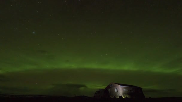 Northern lights over the camper-van and cabin — Stock Video