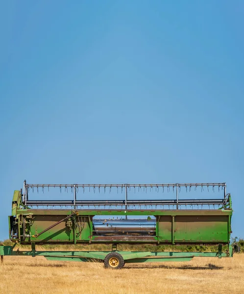 Combine harvester comb under blue sky for text — Photo