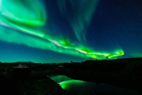 Northern lights ray lights with dark water canal light reflections