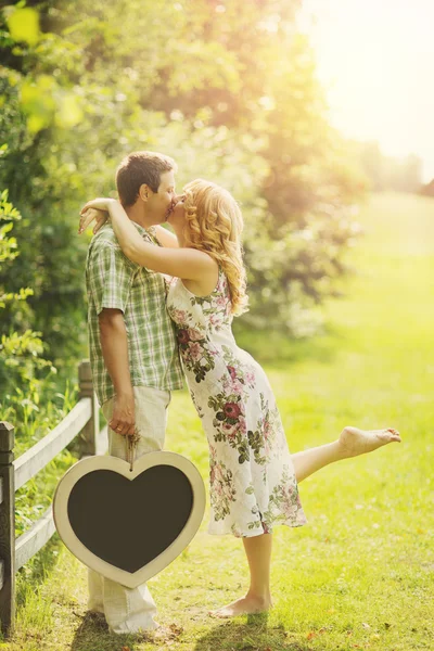 Пара тримає крейдяну дошку у формі серця — стокове фото