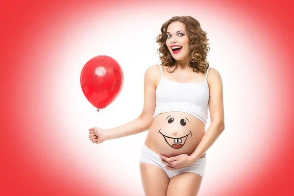 Pregnant woman holding balloon — Stock Photo, Image