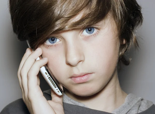 anlayışlı bir görünüm mavi gözlü çocuğun yüzünü telefon ile