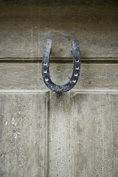 Wooden door with horseshoe — Stock Photo, Image