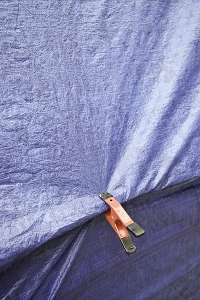 Blue fabric texture and clamp — Stock Photo, Image