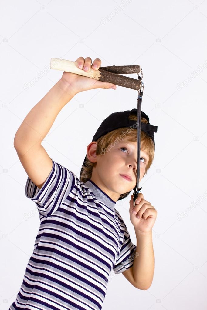 Boy shoots a slingshot