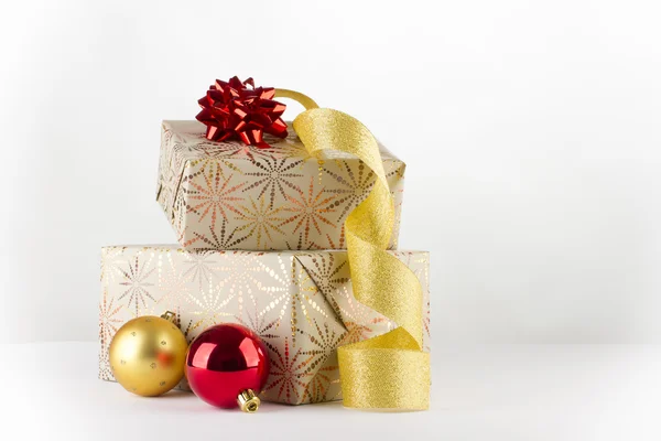 Christmas gifts with golden ribbon — Stock Photo, Image