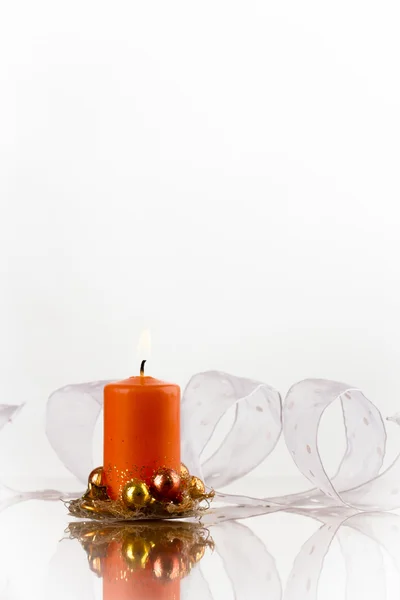 Orange candle and white ribbon — Stock Photo, Image