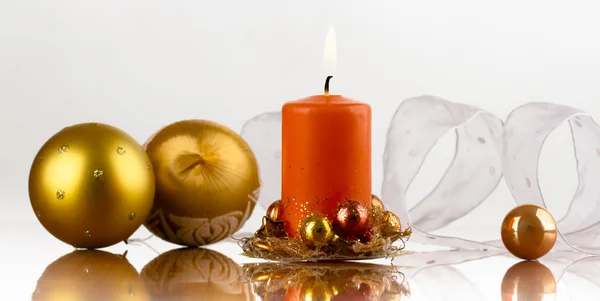 Golden cup, orange candle — Stock Photo, Image