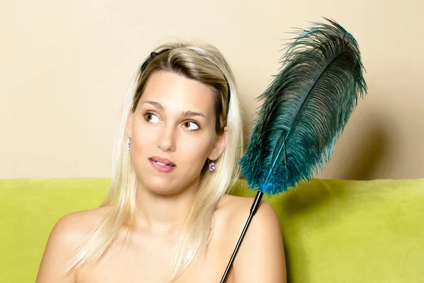 Woman with an ostrich feather — Stock Photo, Image