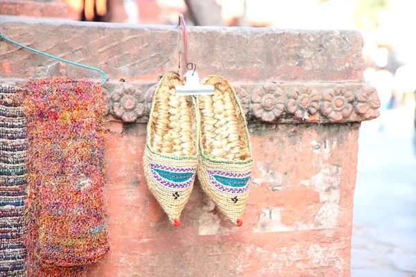 Straw slippers on street — Stock Photo, Image