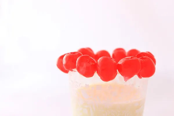 Cherries over milk glass — Stock Photo, Image