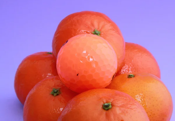 Tangerines & golf ball — Stock Photo, Image