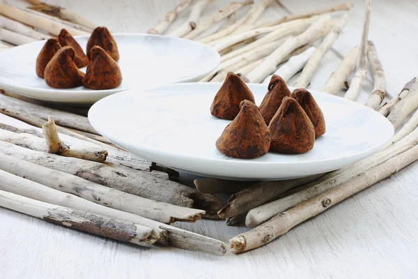 Chocolate truffles on saucers — Stock Photo, Image