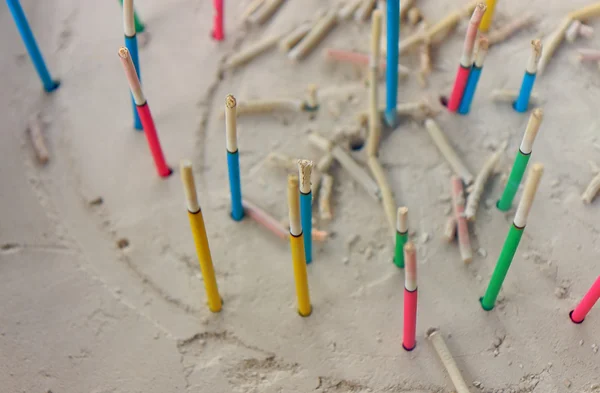 Colored sticks in sand — Stock Photo, Image