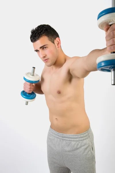 Muscular young man with dumbbells — Stock Photo, Image