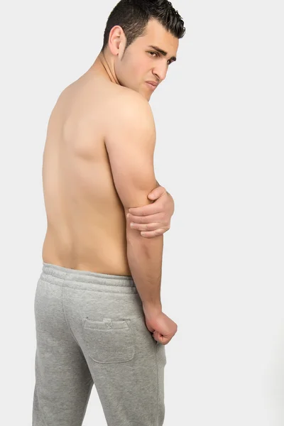 Muskularny mężczyzna z bólem mięśni — Zdjęcie stockowe
