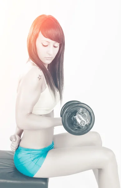 Muscular young girl with dumbbells — Stock Photo, Image