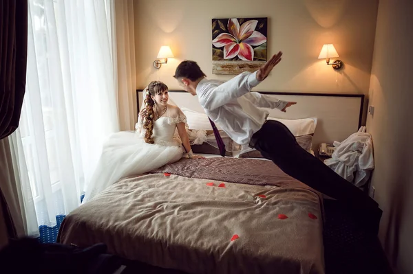 Newly married couple lie on the bed — Stock Photo, Image