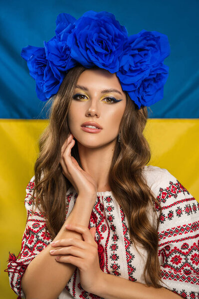 Beautiful Ukrainian woman with patriotic makeup and blue wreath