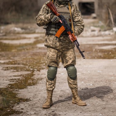 A soldier from Ukraine holds a Kalashnikov assault rifle in his hands