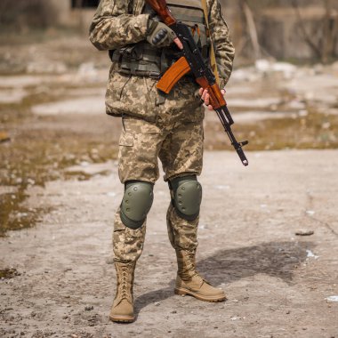A soldier from Ukraine holds a Kalashnikov assault rifle in his hands
