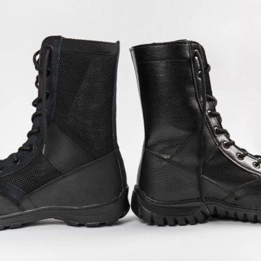 Beyaz arka planda izole edilmiş deri askeri taktik botlar.